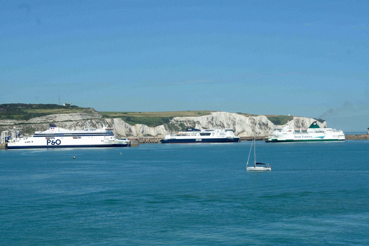 Ferries in Dover harbour below the White Cliffs, seen from the sea